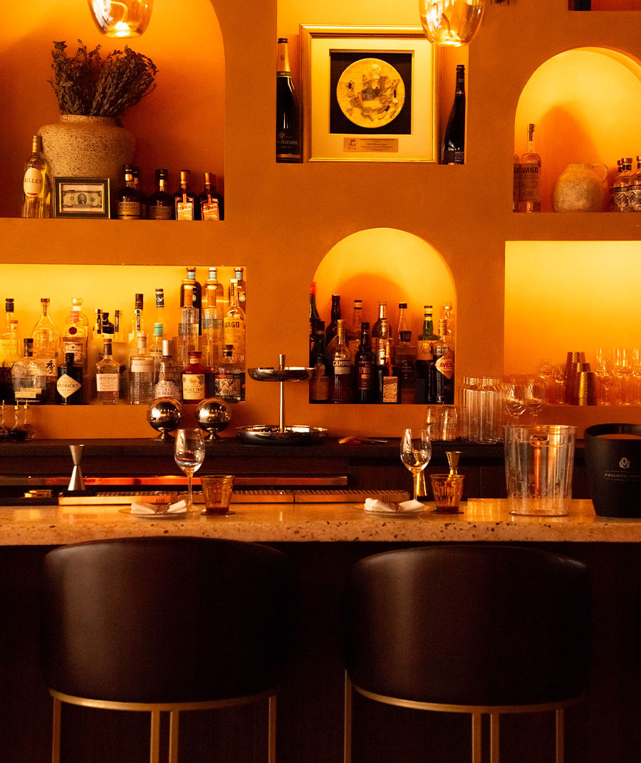 The bar and its warm arched niches